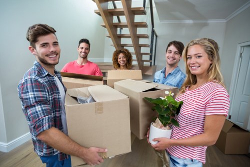 Moving team handling house removals in West Kensington street setting