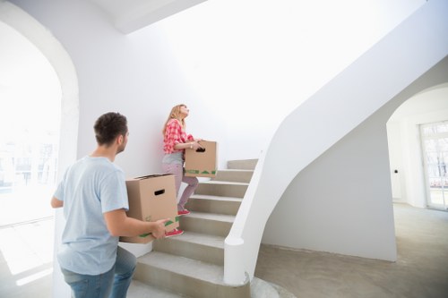 Local piano removal crew navigating stairs and narrow access in West Kensington