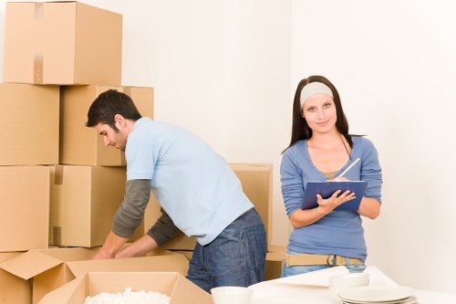 Professional moving team handling boxes and furniture in West Kensington