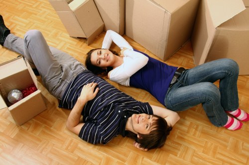 Preparing packed boxes and furniture for collection by a man with a van